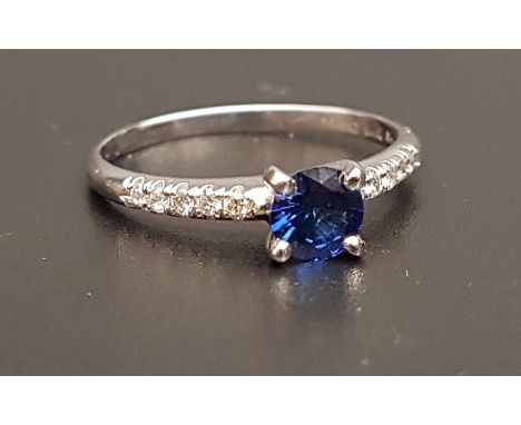 SAPPHIRE AND DIAMOND RINGthe central round cut sapphire approximately 0.5cts flanked by diamond set shoulders, on fourteen ca