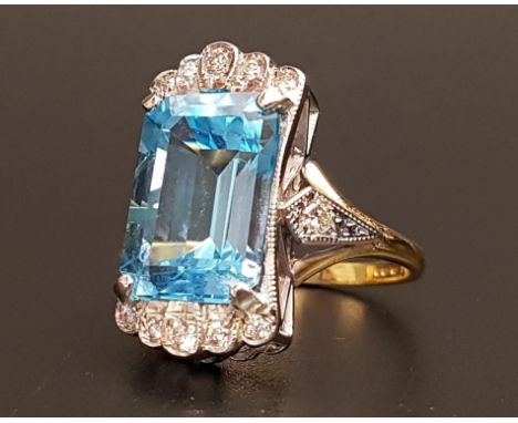 IMPRESSIVE BLUE TOPAZ AND DIAMOND COCKTAIL RINGthe large emerald cut blue topaz measuring approximately 14.5mm x 9.8mm x 6.9m