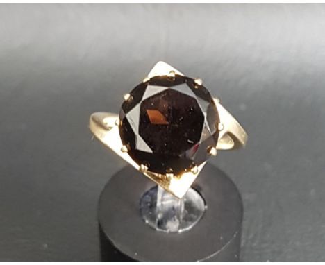 UNUSUAL MALCOLM GRAY FOR ORTAK TOPAZ SINGLE STONE RINGthe round brilliant cut smoky topaz on nine carat gold shank with geome