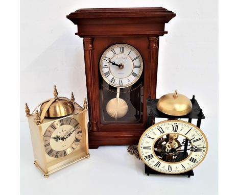 LONDON CLOCK COMPANY MANTLE CLOCKin a mahogany case with a circular dial with Roman numerals and a quartz movement, 37cm high