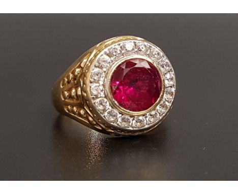 IMPRESSIVE RUBY AND CZ DRESS RINGthe central bezel set round cut ruby approximately 2.5cts in sixteen CZ surround, on fourtee