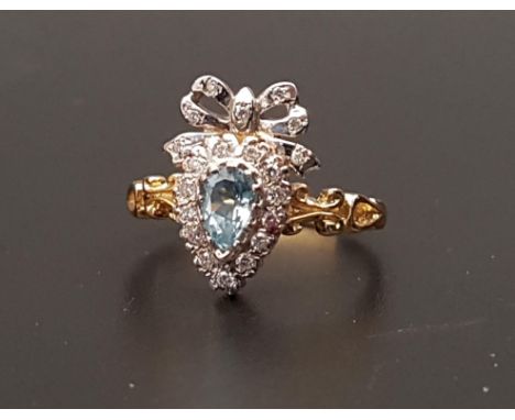 UNUSUAL BLUE TOPAZ AND DIAMOND CLUSTER RINGthe pear cut topaz in diamond surround and surmounted by a diamond set bow, on nin