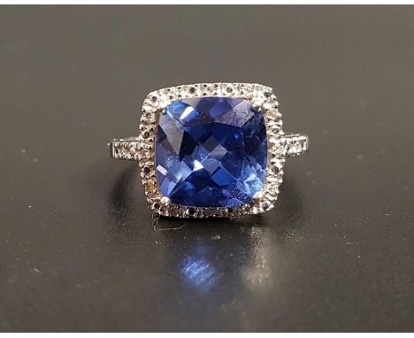 TANZANITE AND DIAMOND CLUSTER DRESS RINGthe central cushion cut tanzanite measuring approximately 9.8mm x 9.8mm x 5.5mm, in i