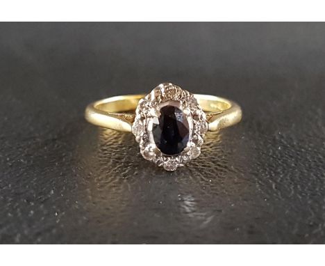 SAPPHIRE AND DIAMOND CLUSTER RINGthe central oval cut sapphire approximately 0.5cts in eight diamond surround, on eighteen ca