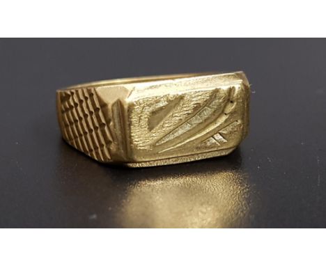 EIGHTEEN CARAT GOLD RINGwith engraved decoration, ring size V and approximately 10.9 grams 