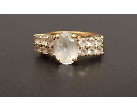 QUARTZ DRESS RINGthe central oval cut gemstone flanked by two rows of smaller quartz gemstones, on nine carat gold shank, rin