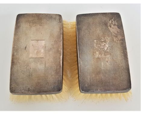 PAIR OF GEORGE V SILVER BACKED MILITARY HAIR BRUSHESof rectangular form with engine turned decoration, Birmingham 1932 (2) 