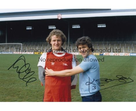 ARSENAL    Col photo measuring 12" x 8", of Kenny Sansom posing with Arsenal's new signing Peter Nicholas during a photo-shoo