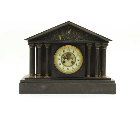 A Victorian architectural slate mantel clock, with Corinthian columns enclosing an enamel dial with brocot escapement, inscri