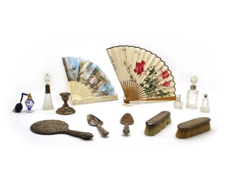 A collection of 17 fans, two silver backed brushes. a silver topped scent bottle, silver dwarf candlestick, embossed hand mir