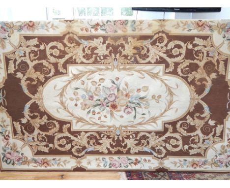 An Aubusson style polychrome tapestry panel, woven with a central panel of flowers within a scrolling foliate field. L. 253cm