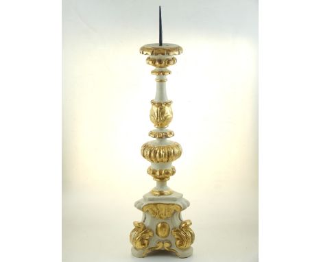 An 18th century and later painted Italian pricket candlestick, carved hardwood with a tripod base, H. 60cm.