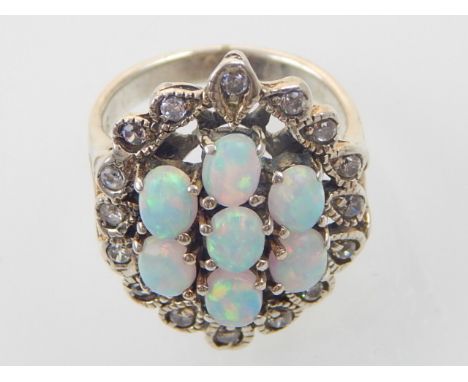 A silver, cubic zirconia and opal set ring in the Art Nouveau style. 