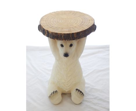 A occasional table, modelled in the form of a polar bear supporting a tree trunk slice, H. 52cm.