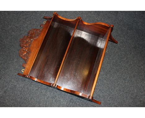 A rosewood wall shelf with three shelves, carved domed top and sides, 49cm