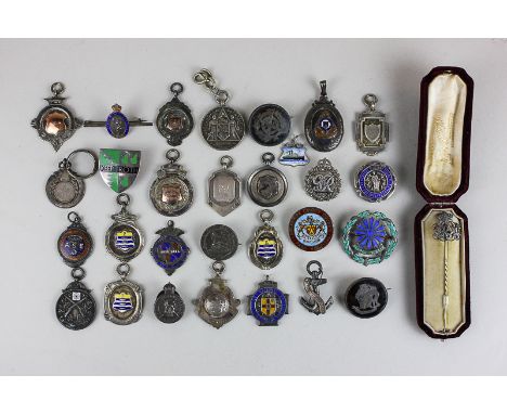 A silver Royal Canadian Ordnance Corps locket, a collection of Military badges and medallions, together with eight silver spo