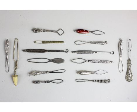 A collection of sixteen Victorian and later silver and metal button hooks