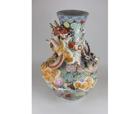 A large Chinese pottery vase with overlaid dragon decoration on brightly coloured enamel and gilt ground, 53cm high