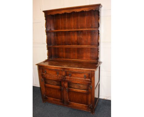 An early 20th century oak dresser with shelf back, two drawers and cupboards, 113cm