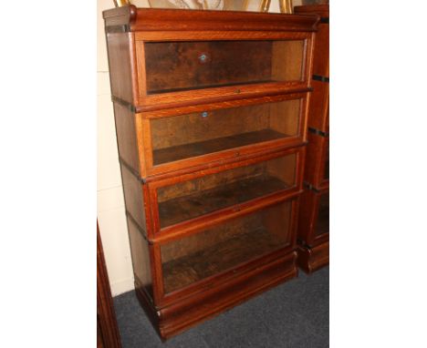 A Globe Wernicke oak four-tier bookcase on plinth base with maker's transfer label, 86cm