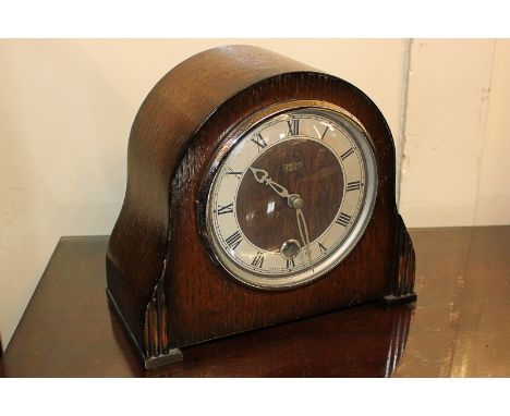 An Art Deco domed oak cased mantel clock by Smiths Enfield, 20cm wide