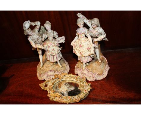 A pair of Sitzendorf porcelain figures of lovers, together with a Continental porcelain framed oval mirror