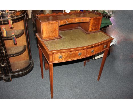 An inlaid mahogany writing desk with raised back of shelf, small cupboards and drawers, green leather writing top and two dra