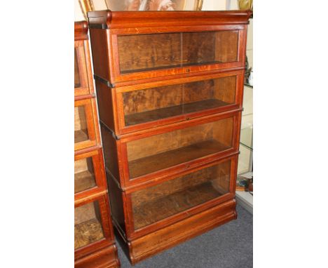 A Globe Wernicke style oak four-tier bookcase on plinth base, 86cm