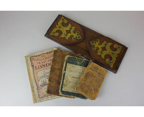 A mahogany folding book slide with brass scrollwork, together with The District Railway Map of London, The New Map of London,