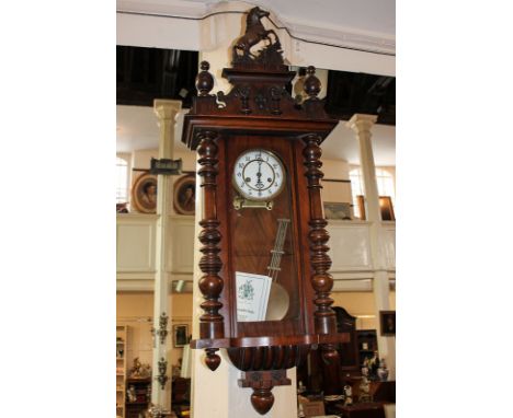 A late 19th century walnut cased Vienna wall dial by Gustav Becker of Silesia, striking on the half hour on a gong, with impr