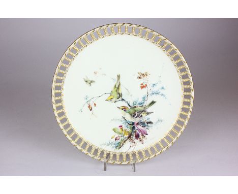 A Royal Worcester porcelain cabinet plate with pierced and gilt border, the centre with hand painted design of two birds in f