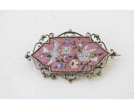 A silver mounted micro-mosaic brooch the shaped rectangular panel depicting doves delivering a 'billet doux' (a/f small patch