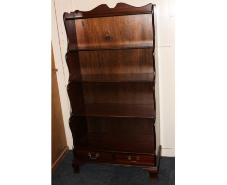 A Foster Clarke of London reproduction mahogany waterfall bookcase of five shelves over two short drawers, on bracket feet, 7