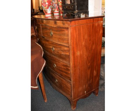 A George III inlaid mahogany bow front chest of two short over three long drawers with brass ring drop handles, on bracket fe