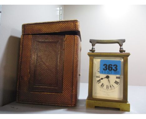An early 20th century brass cased carriage clock, the white enamelled dial with Roman numerals 3 3/4h and a larger brown clad