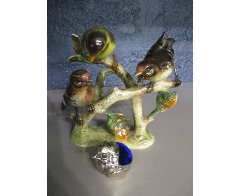 A Goebel figural group depicting three wild birds, a white metal pin cushion in the form of a baby bird