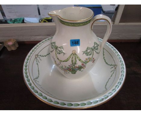 A Spode Copeland wash jug and bowl decorated with floral bows, swags and pendant baskets of flowers, retailed by Thomas Goode