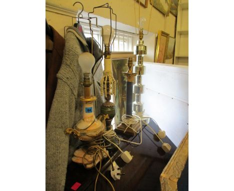 A gilt metal and variegated marble table lamp, a gilt brass and patinated, Corinthium pattern table lamp and two other table 
