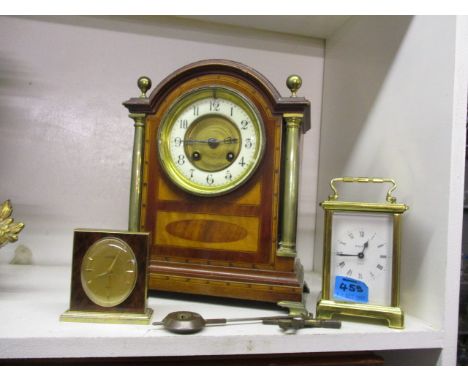 A group of three clocks to include a late Victorian mahogany and marquetry mantle clock with cream enamelled dial, 11 h