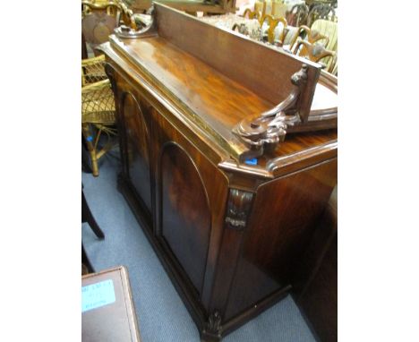 A mid Victorian mahogany chiffoniere, the up-stand having a carved crest over a shelf, the base comprising canted flanks and 