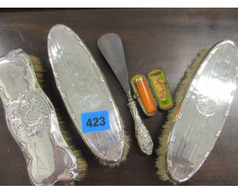 Three silver backed brushes, a silver shoe horn and a gold banded and amber cheroot