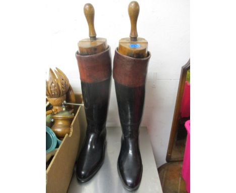 Brown and black leather riding boots with wooden shoe trees