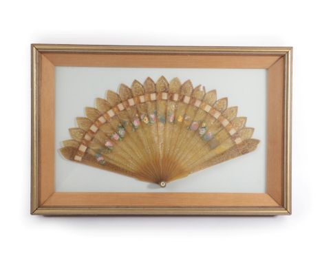An Early 19th Century Horn Brisé Fan painted in pastels with flowers, the eighteen inner sticks and two guards with pointed t