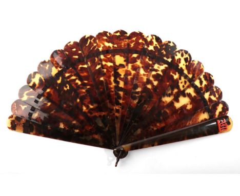 A Late 19th Century Tortoiseshell Brisé Fan, plain save for the initials AM in coral, mounted on both guards.  Seventeen inne