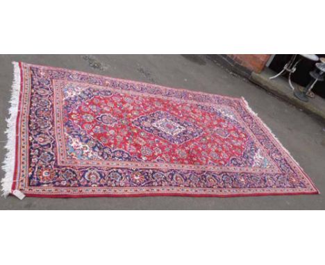 Blue and red ground fringed carpet. Condition report: see terms and conditions