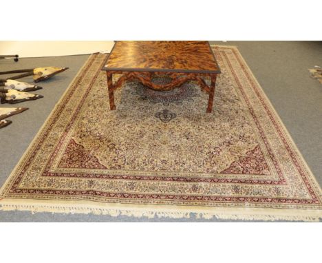 A machine made carpet of Oriental design, 333cm by 239cm