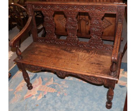An early 20th century carved oak bench, 106cm wide 