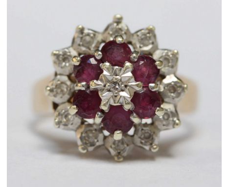 A 9ct gold, ruby and diamond flower head cluster ring. 4 grams