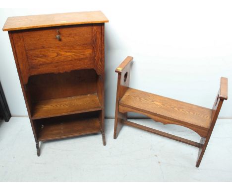 A 1920s oak bench, the arms pierced with heart shapes, together with a 1920s small oak fall front bureau. (2)