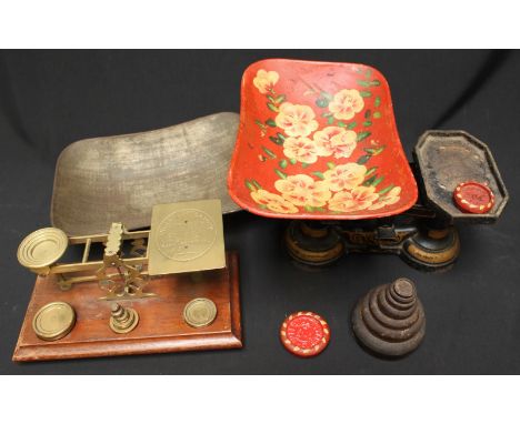 A set of Brass postal scales on wooden base together with a set of painted metal kitchen scales, both with measuring weights,